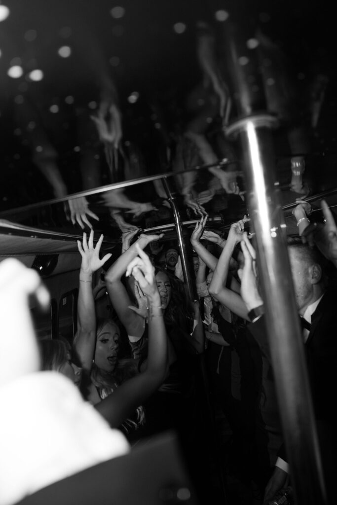 Bride and groom on a party bus with their guests