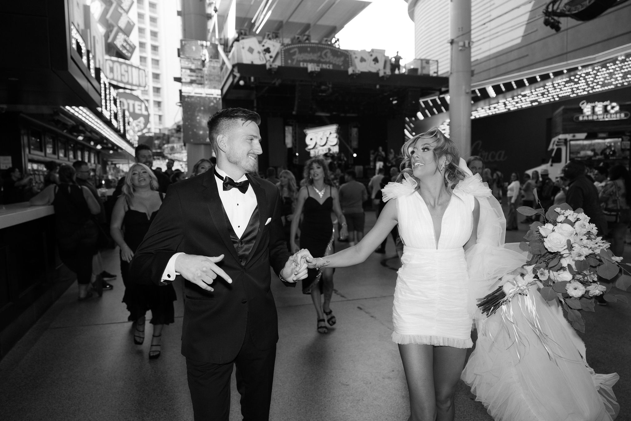 Bride and grooms walking down Fremont Street after their Las Vegas elopement