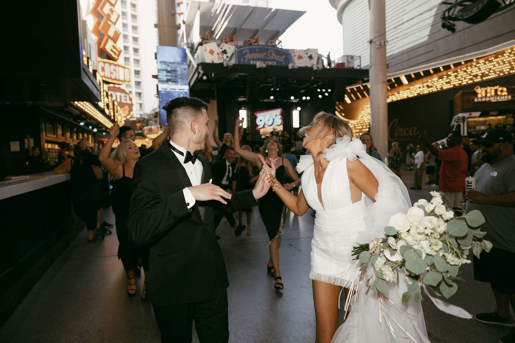 Bride and grooms walking down Fremont Street after their Las Vegas elopement