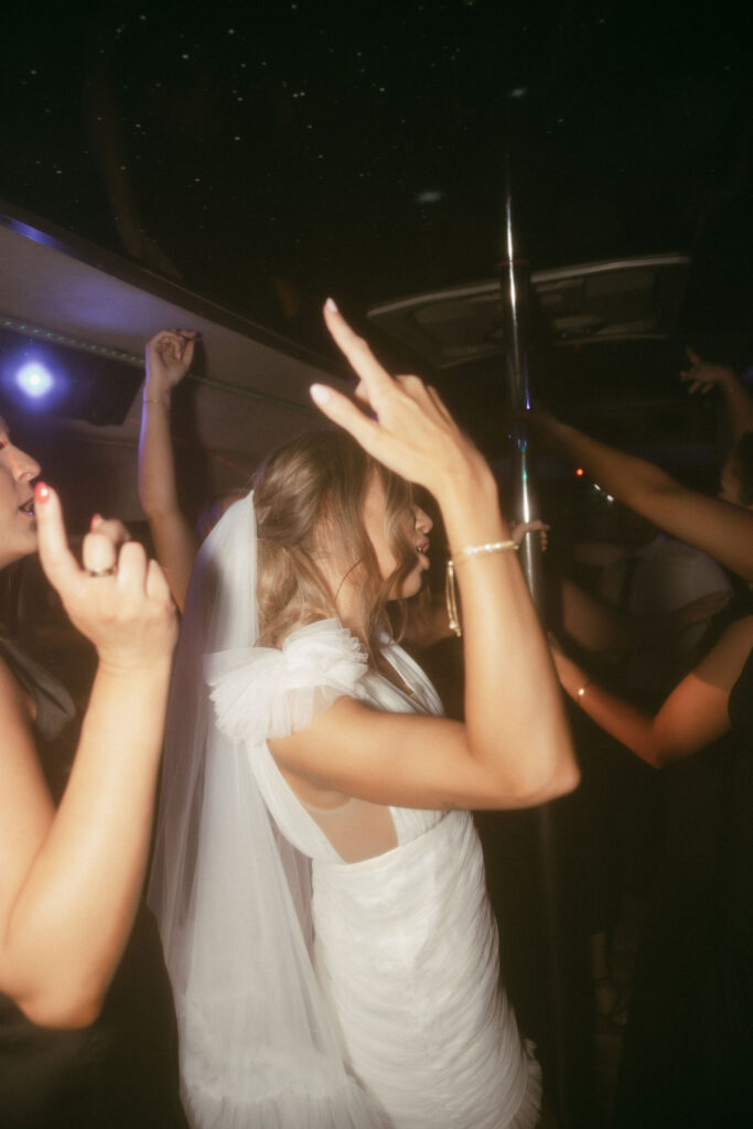 Bride and groom on a party bus with their guests