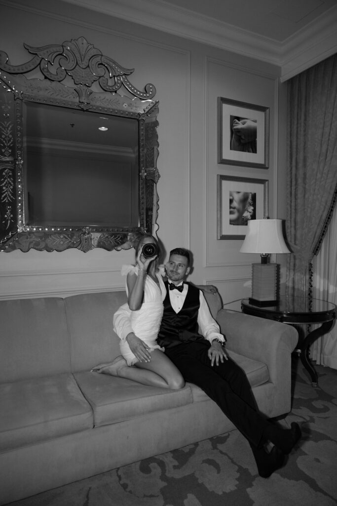 Bride and groom sitting on the couch and drinking champagne