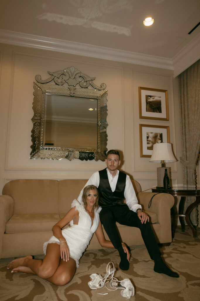 Bride and groom sitting on a couch 