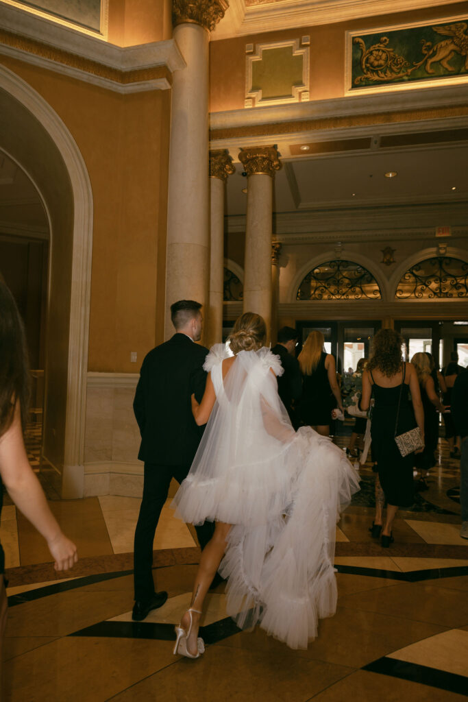 Bride and groom walking to their party bus