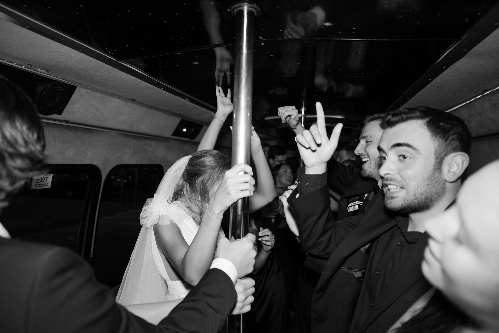 Bride and groom on a party bus with their guests