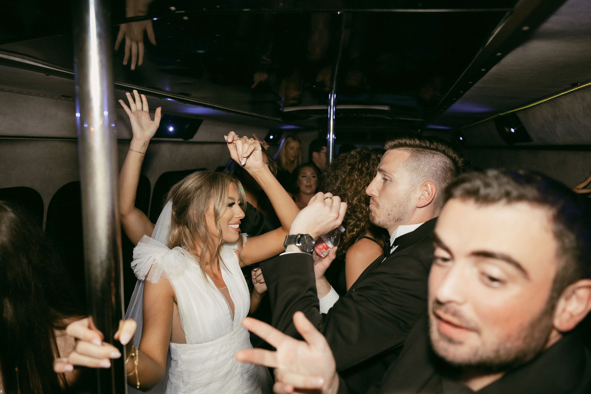 Bride and groom on a party bus with their guests