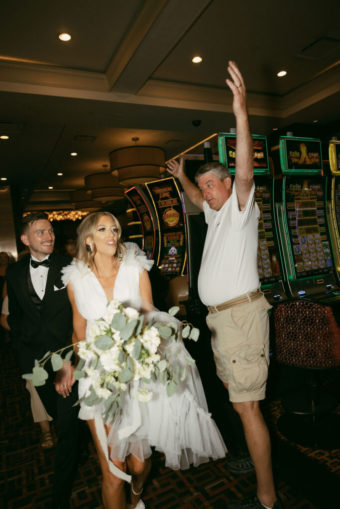 Bride and groom walking through the casino