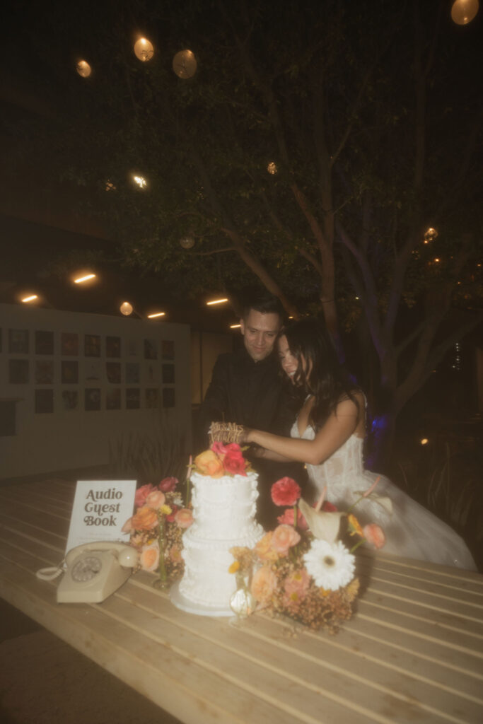 Bride and groom cutting into their wedding cake