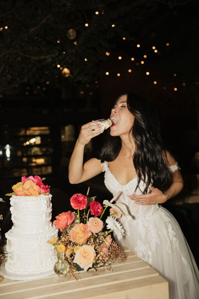 Bride eating a slice of wedding cake