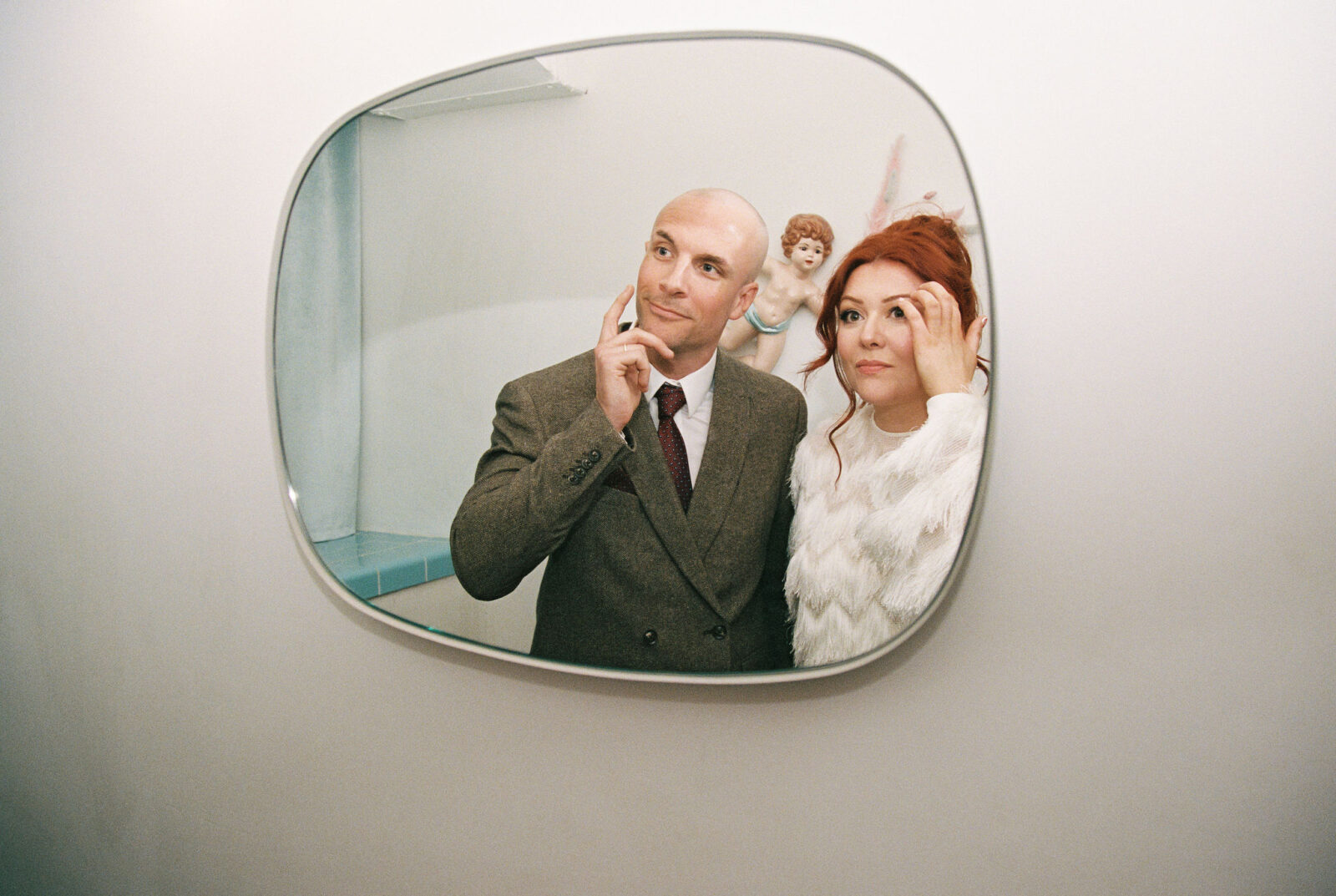 Bri9de and groom posing for photos in the bathroom at Sure Thing Chapel