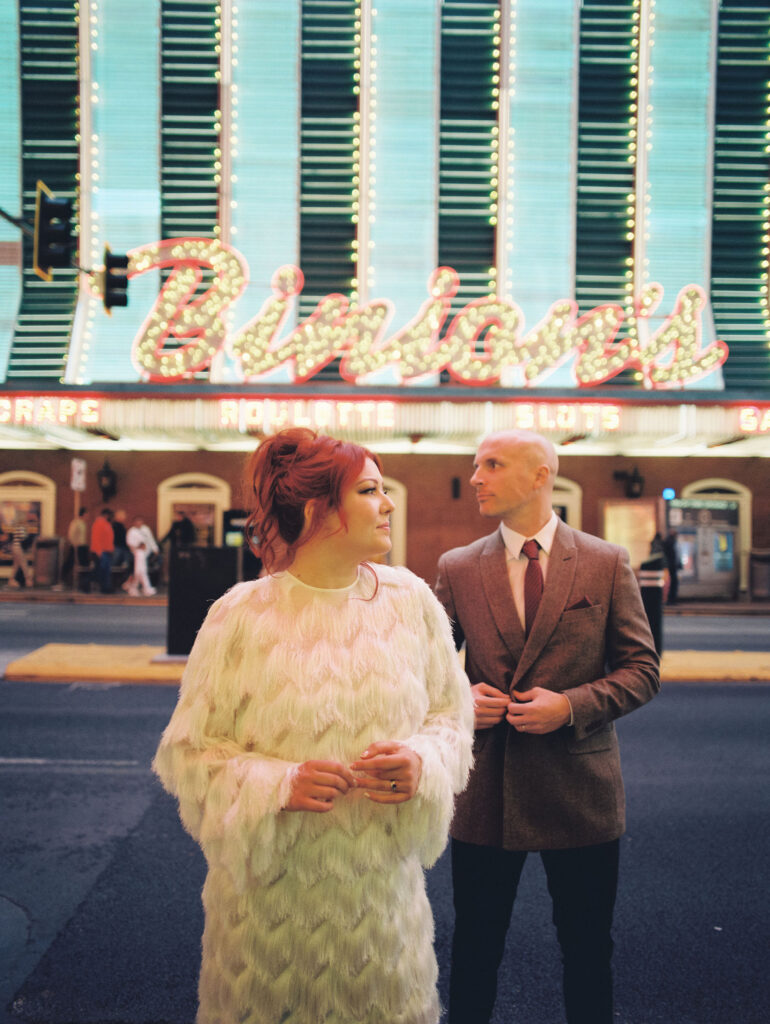 Bride and groom walking around Fremont Street in Vegas