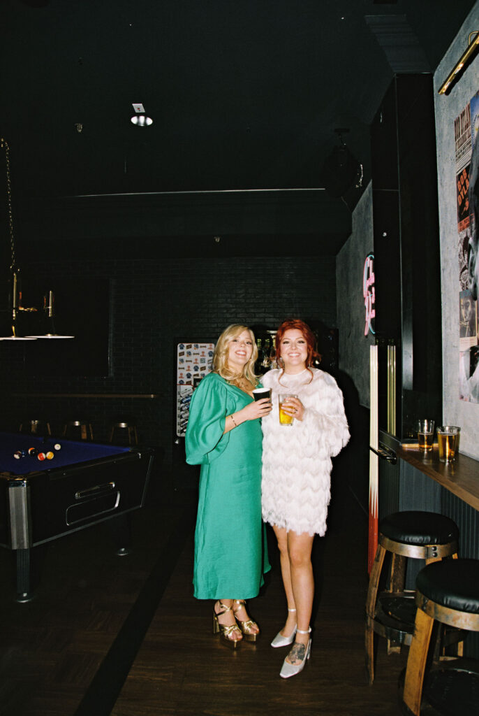 Bride posing for photos with guest