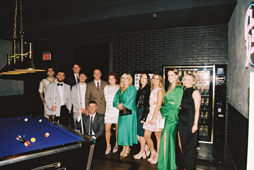 Bride and groom posing for photos with their elopement guests