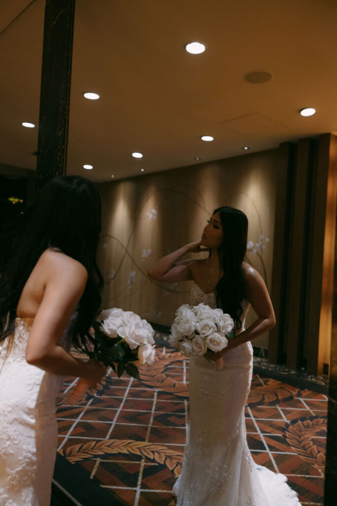 Bride looking at herself in the mirror at Caesar's Palace in Las Vegas