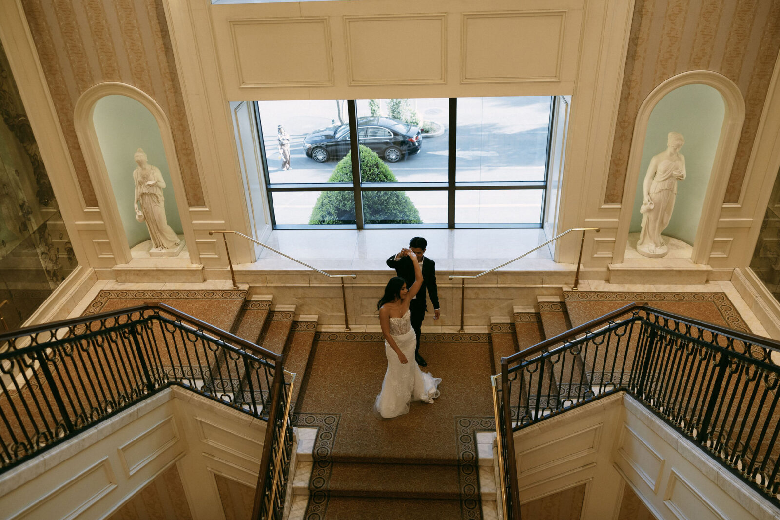 Bride and groom dancing on the staircase at Caesars Palace in Las Vegas