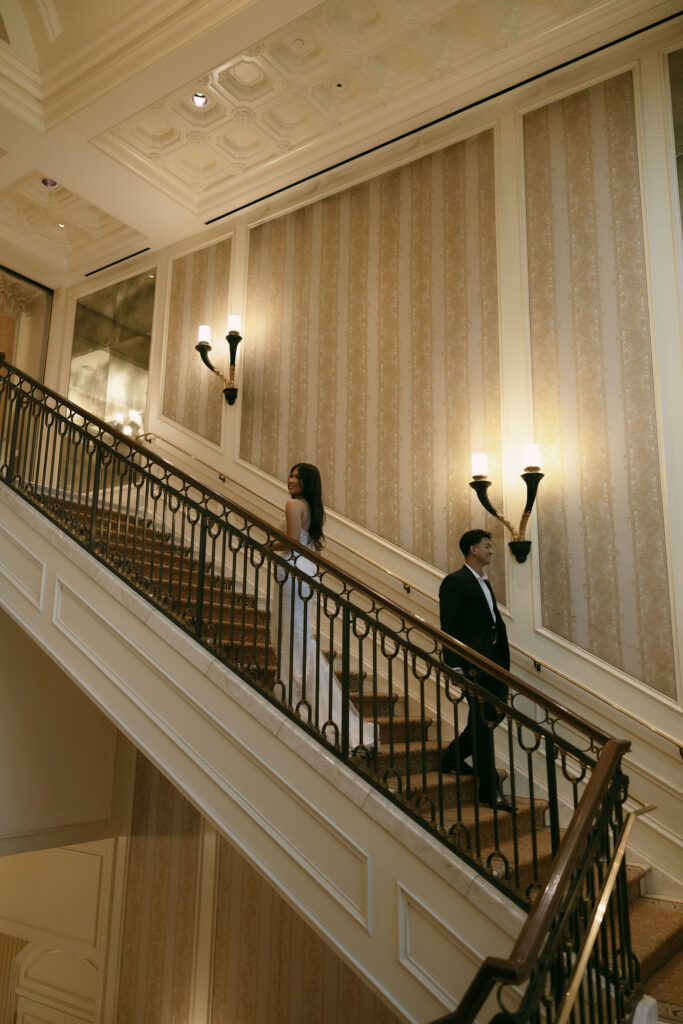 Bride and groom walking on the staircase at Caesars Palace in Las Vegas.