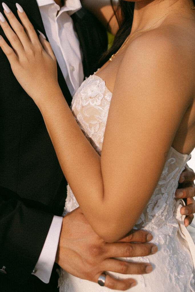 Close up crop of a bride and groom holding eachother