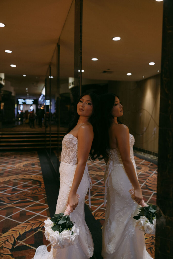 Bride leaning up against a mirror for portraits at Caesars Palace in Las Vegas