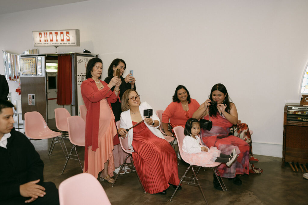 Wedding guests taking photos at Sure Thing Chapel in Las Vegas. 