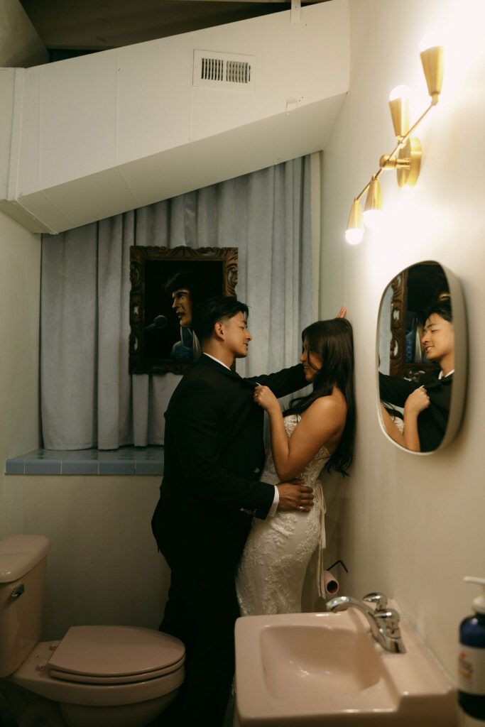 Bride and groom in bathroom for photos at Sure Thing Chapel