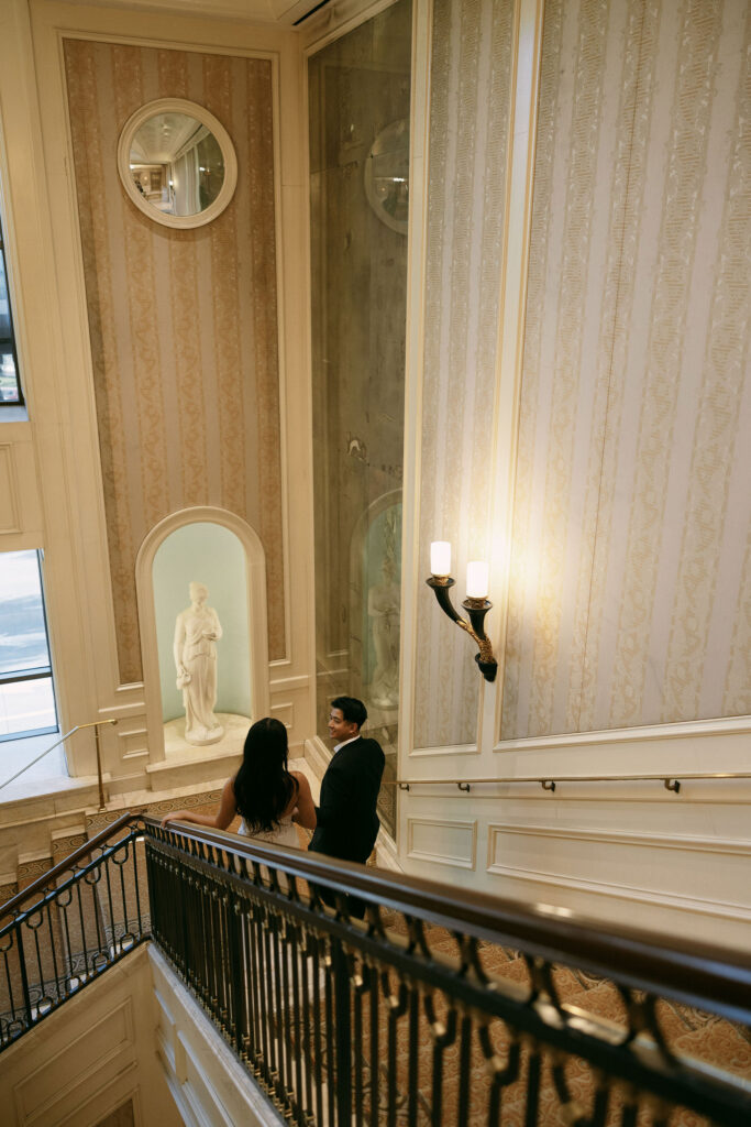 Bride and groom walking down the staircase at Caesars Palace in Las Vegas.