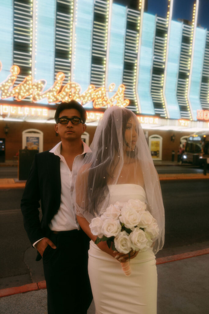 Bride and groom posing for photos on Fremont Street