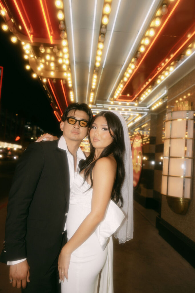 Flash photos of a bride and groom on Fremont Street