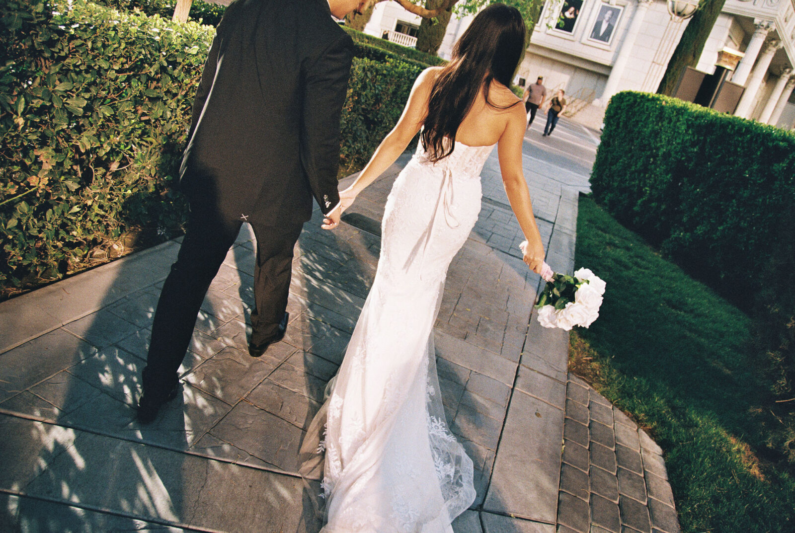 Film photo of a bride and groom walking at Caesars Palace in Las Vegas