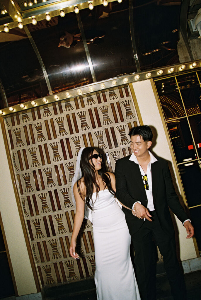 Bride and grooms film photos from their Las Vegas elopement on Fremont Street. 