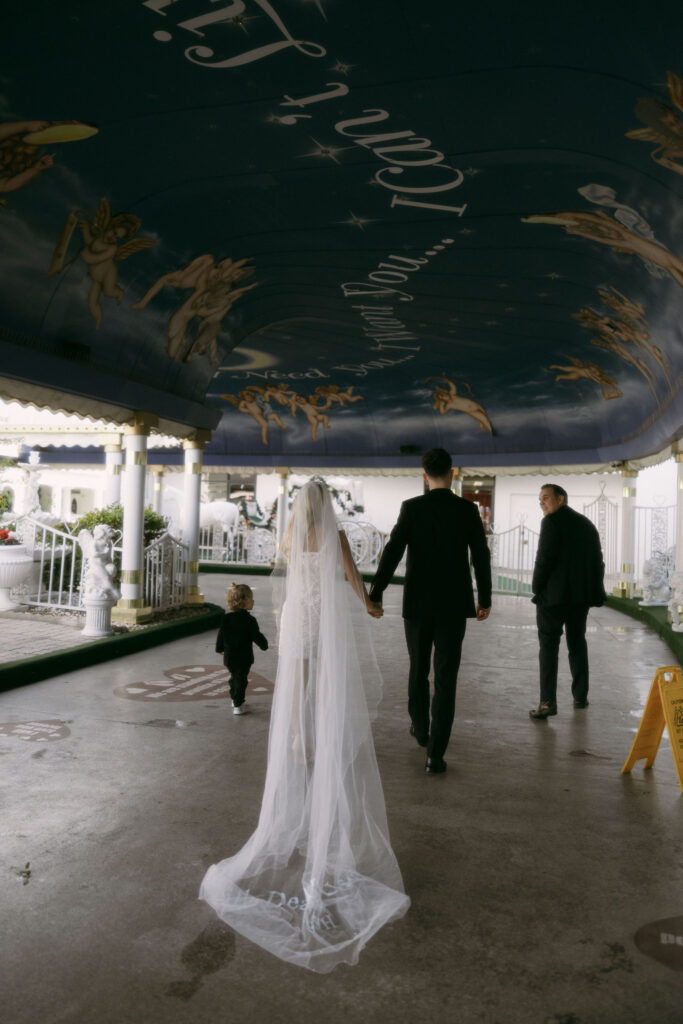 Bride and groom walking to The Tunnel of Love