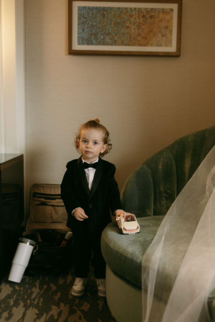 Bride and grooms son playing with car