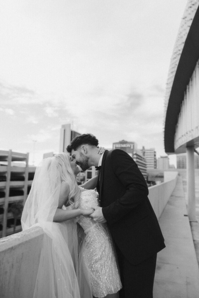 Black and white portrait of a bride and groom on a rooftop