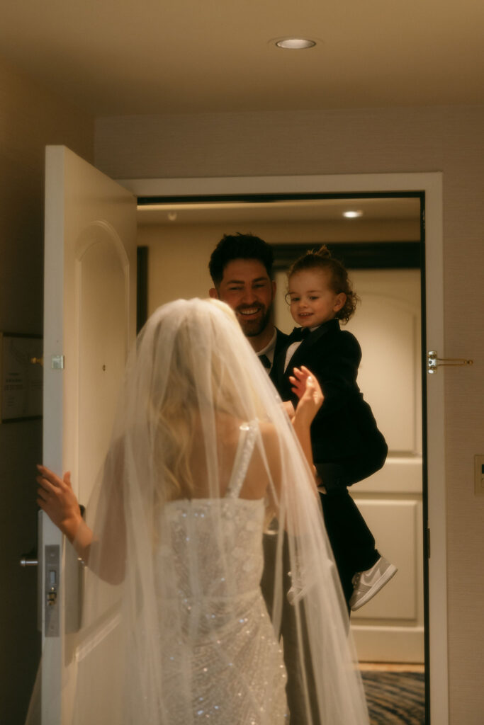 Bride opening the door for her fiance and son