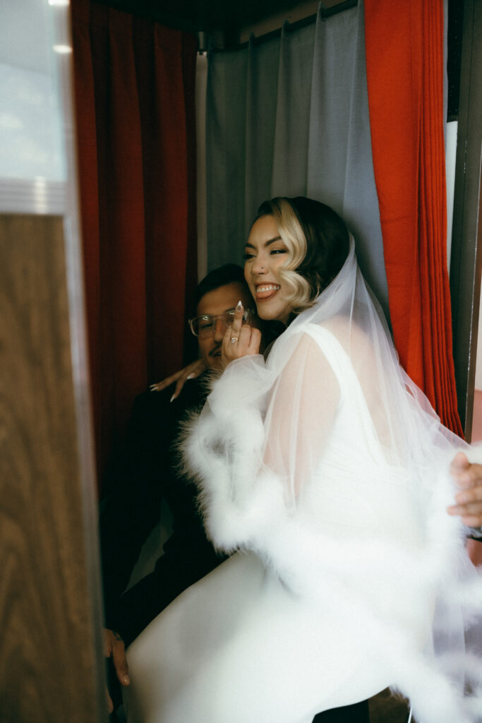 Bride and groom getting their picture taken in Sure Thing Chapels photo booth