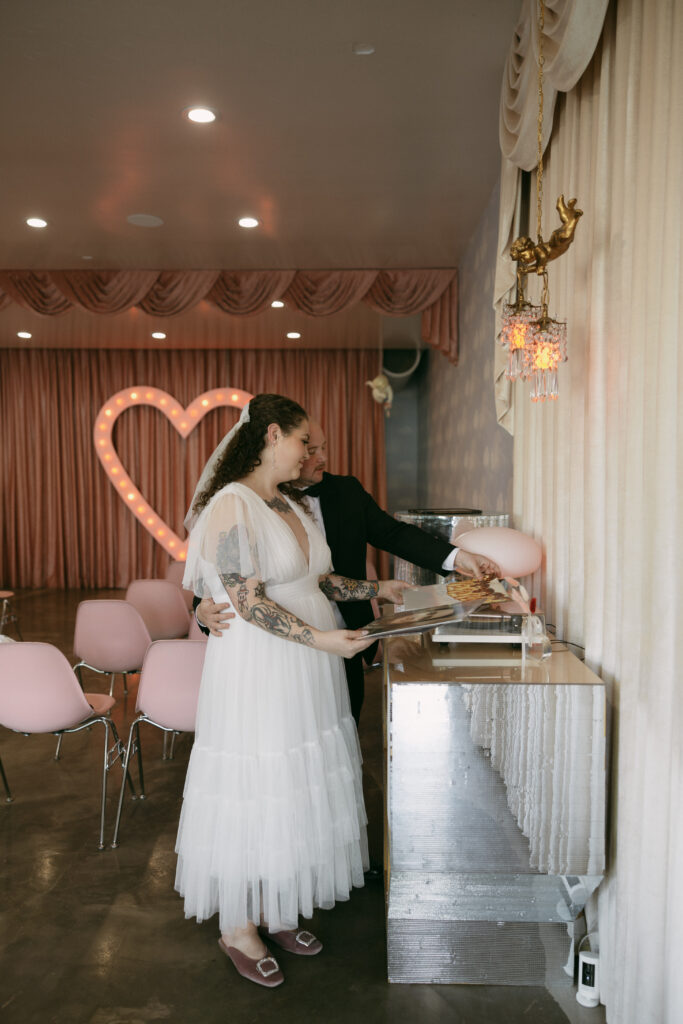 Bride and groom picking out a record at Sure Thing Chapel