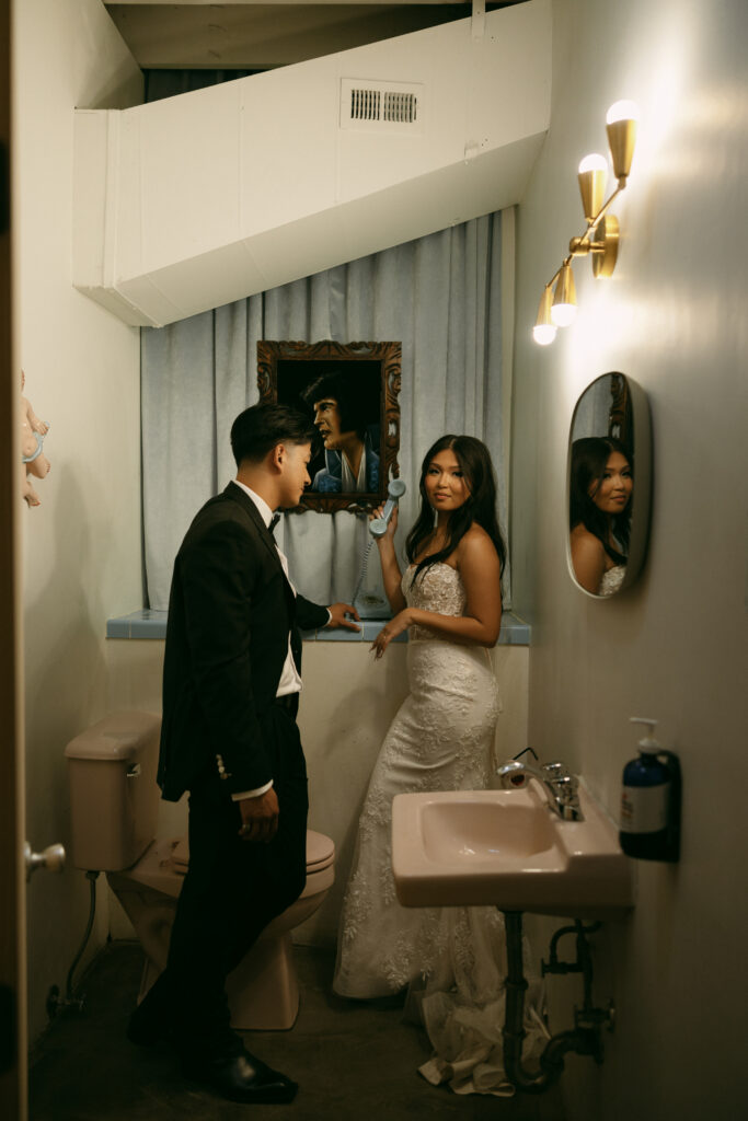 Bride and groom posing in the Sure Thing Chapel bathroom