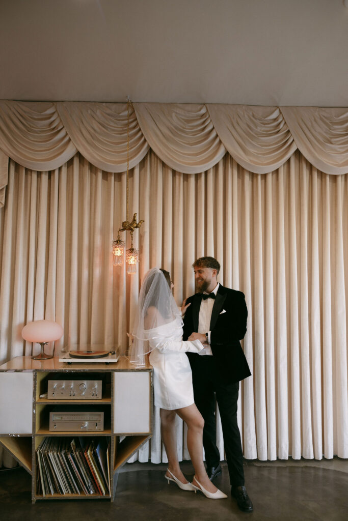 Bride and groom listening to a record at Sure Thing Chapel during their elopement