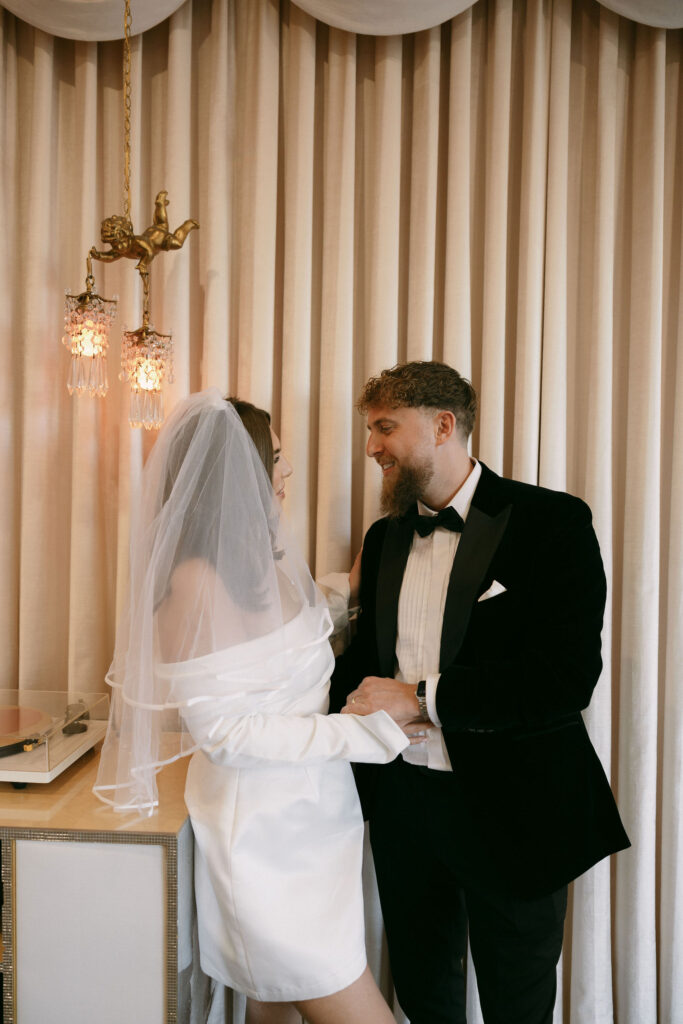 Bride and groom listening to a record at Sure Thing Chapel during their elopement