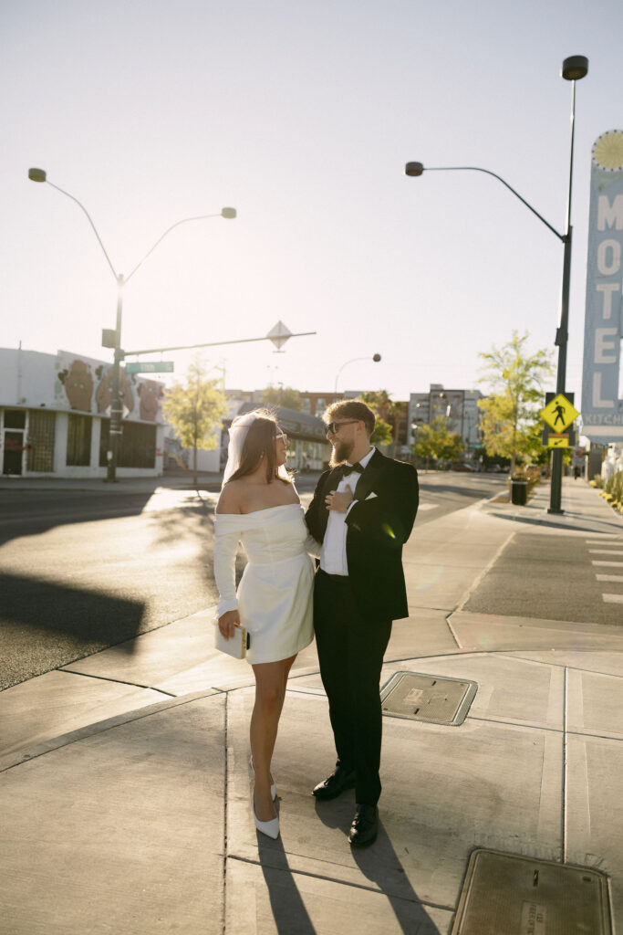 Bride and groom standing at a corner in downtown Las Vegas for portraits. 