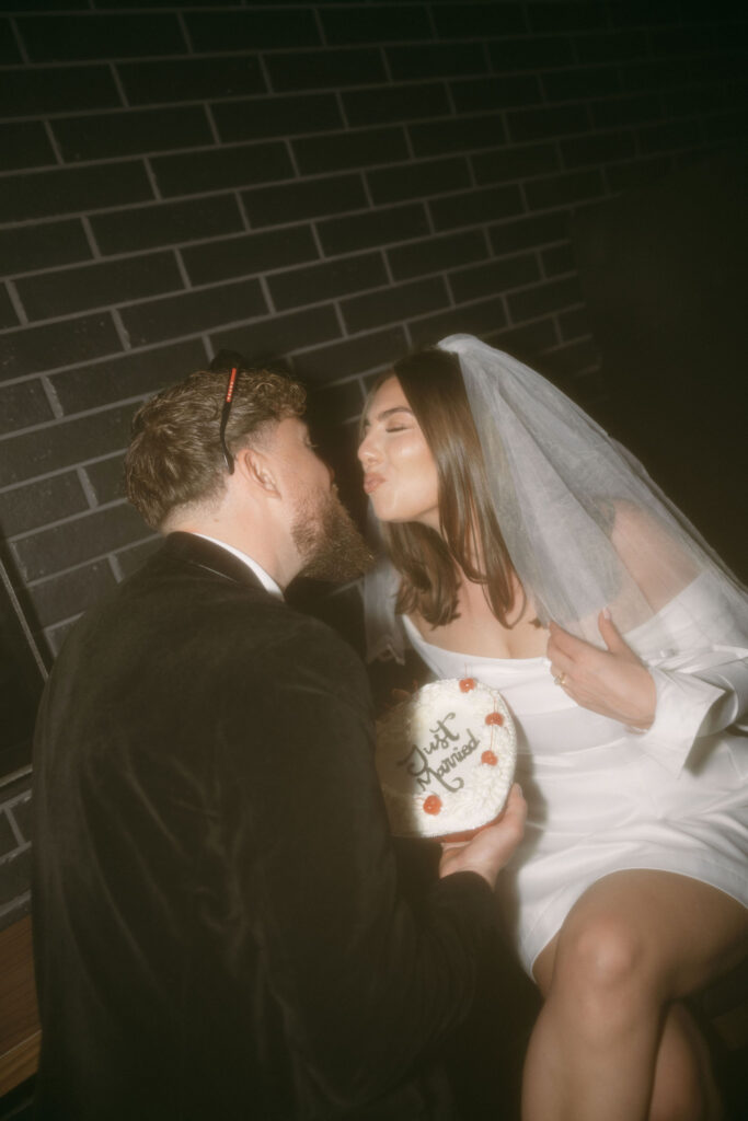 Bride and groom with their vintage Vegas elopement cake