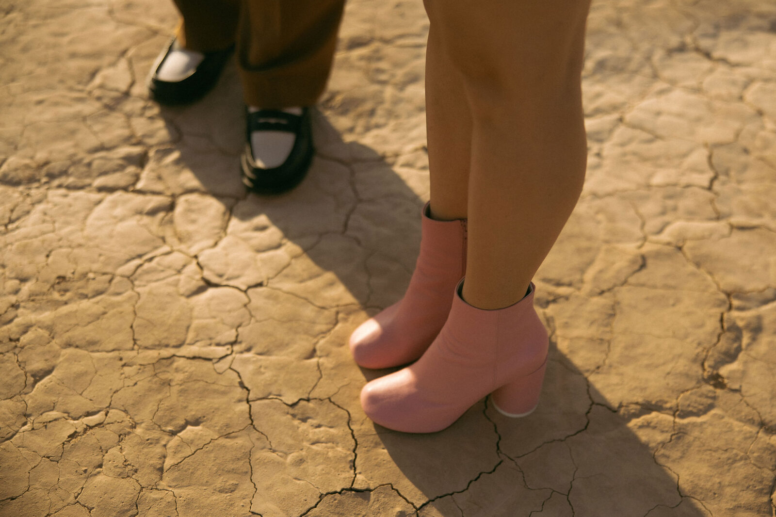 Close up shot of a groom and brides shoes