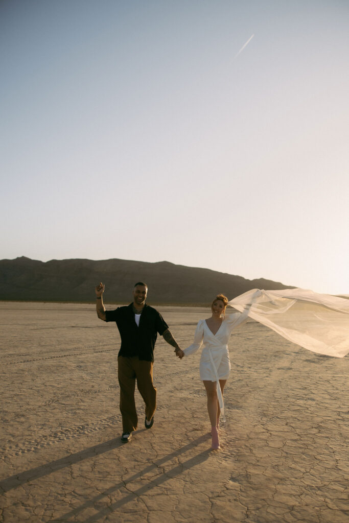 Bride and groom celebrating after their Dry Lake Bed Las Vegas wedding ceremony at sunset