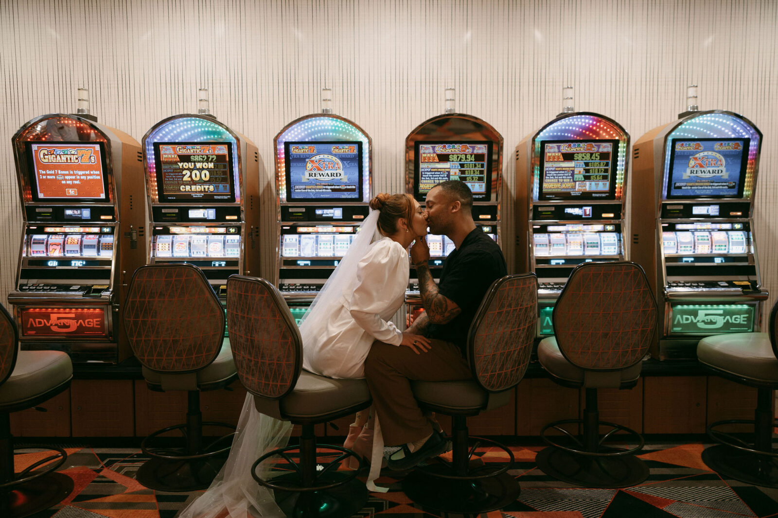 Bride and groom kissing at the slots in Las Vegas for their wedding photos