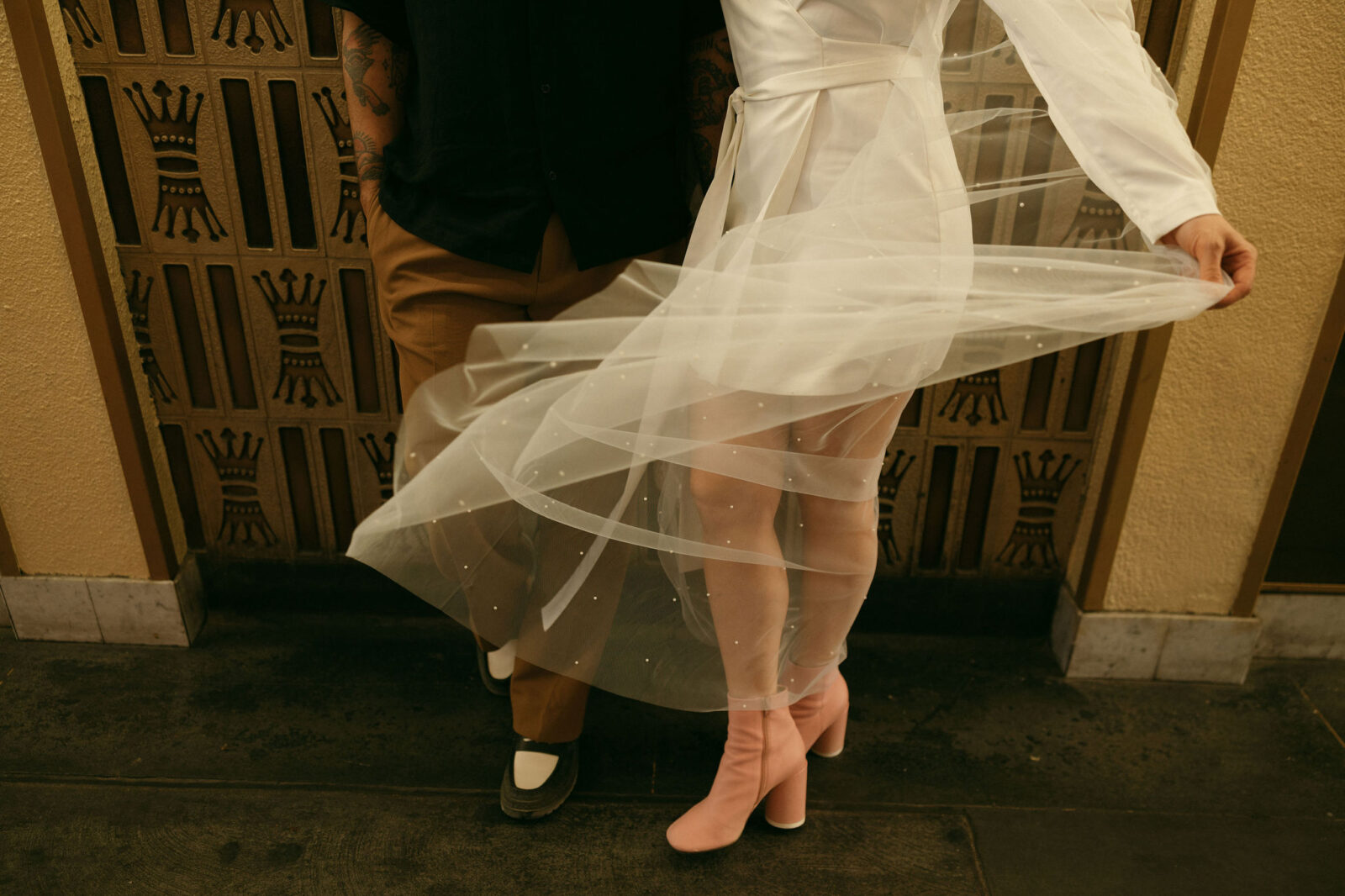 Close up shot of a bride and grooms elopement outfits