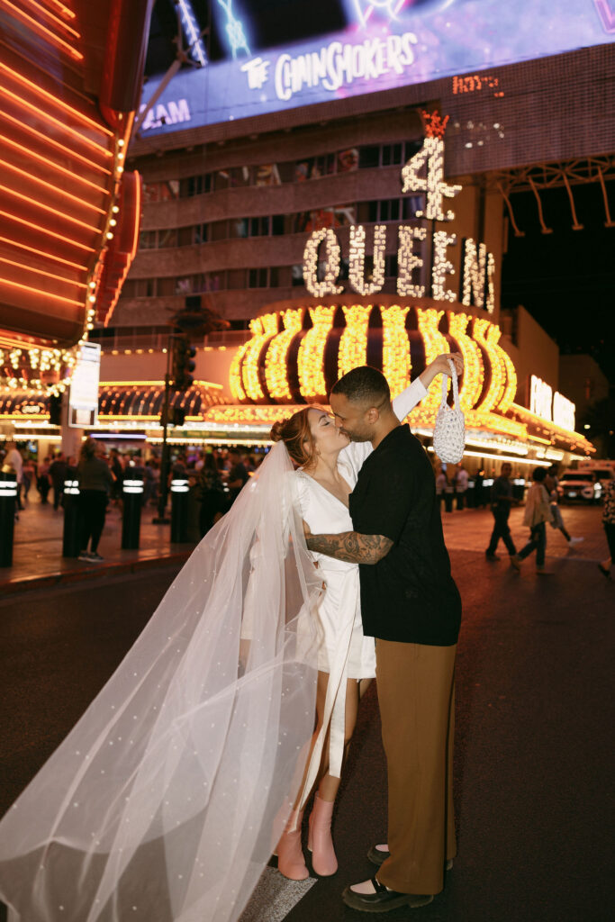 Bride and groom kissing in downtown Las Vegas for their portraits 