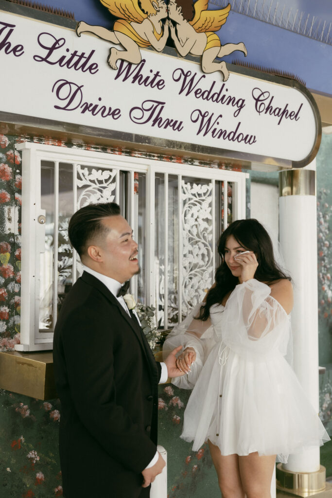 Bride and groom getting married at The Little White Wedding Chapels Drive Thru Window in Las Vegas