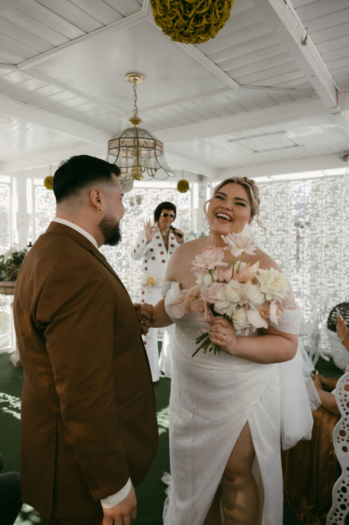 Bride and groom getting married by an Elvis impersonator in the Gazebo at The Little White Wedding Chapel