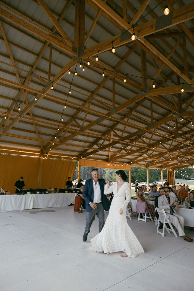 Bride and her father doing a choregraphed wedding dance during mother father dances