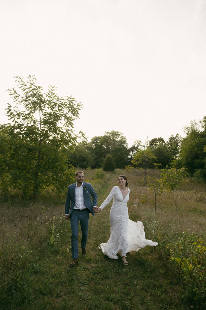 Bride and grooms outdoor sunset wedding portraits during their summer camp wedding in Wisconsin