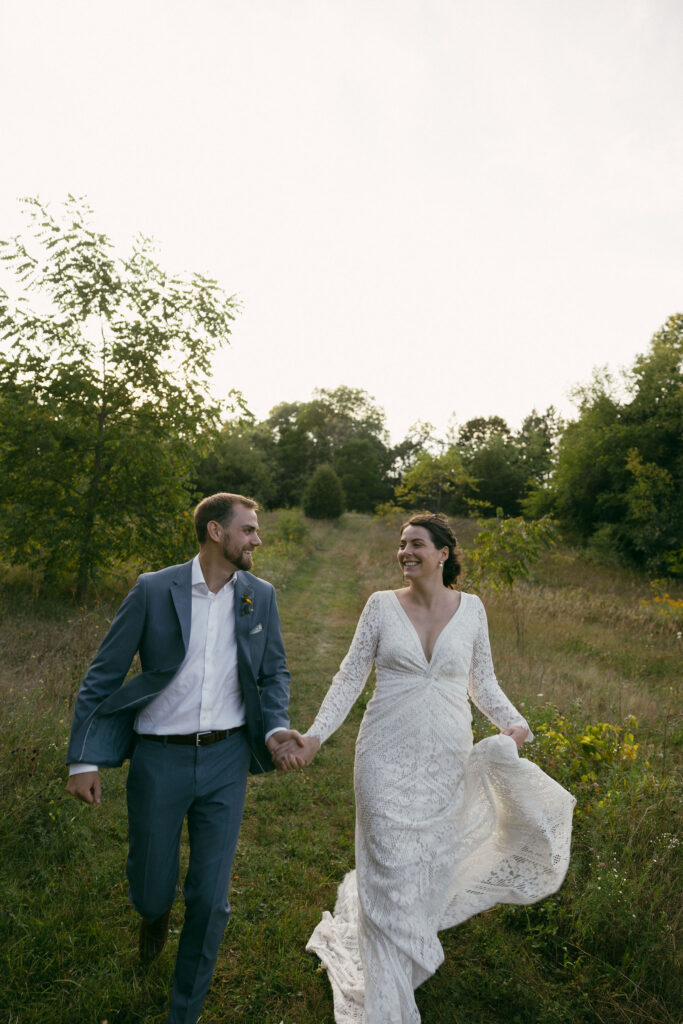 Bride and grooms outdoor sunset wedding portraits during their summer camp wedding in Wisconsin