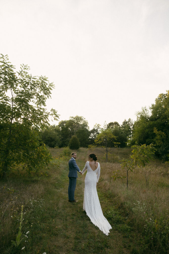 Bride and grooms outdoor sunset wedding portraits during their summer camp wedding in Wisconsin